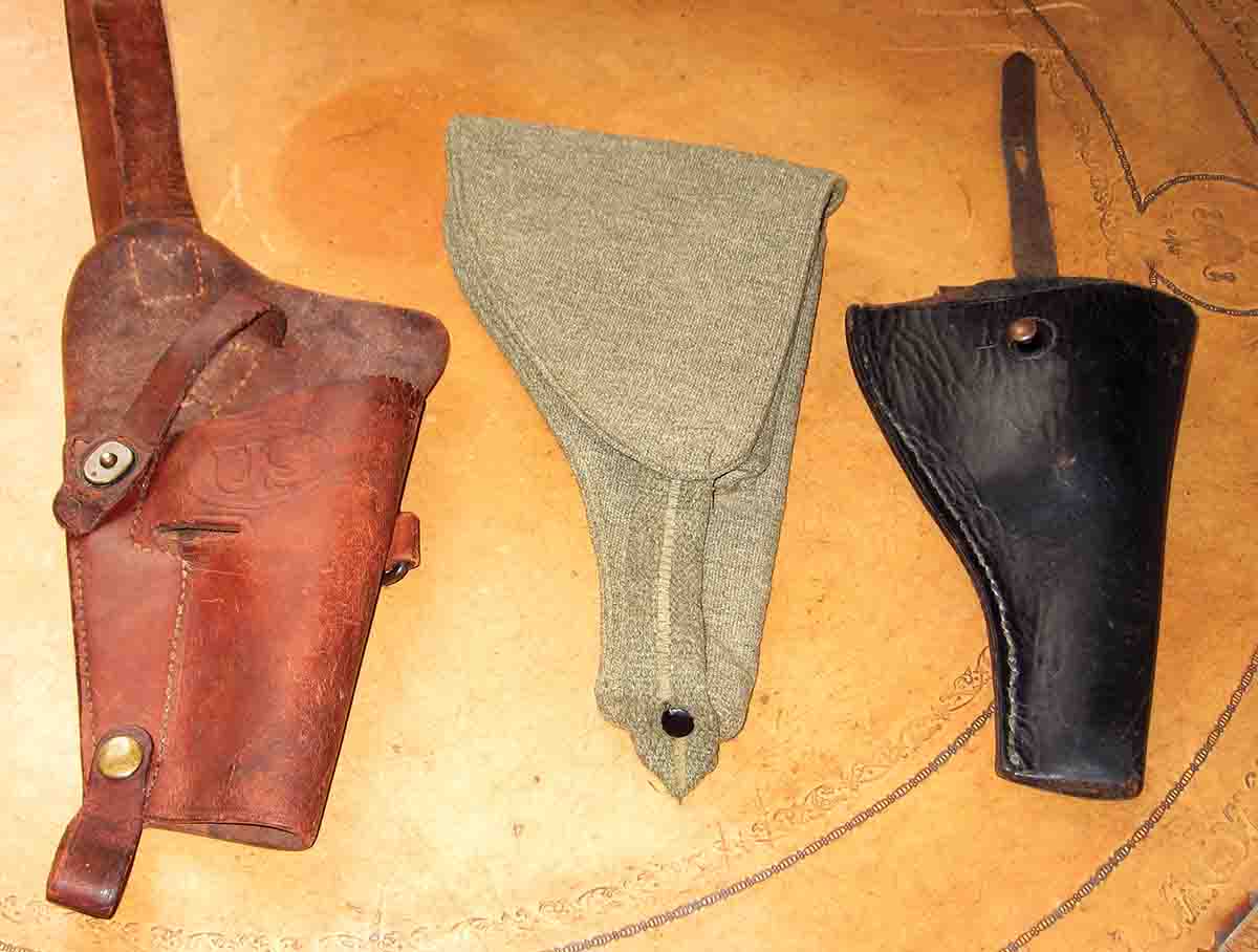 WWII USMC stamped shoulder holster, WWII British cloth type & Irish Constabulary holster.